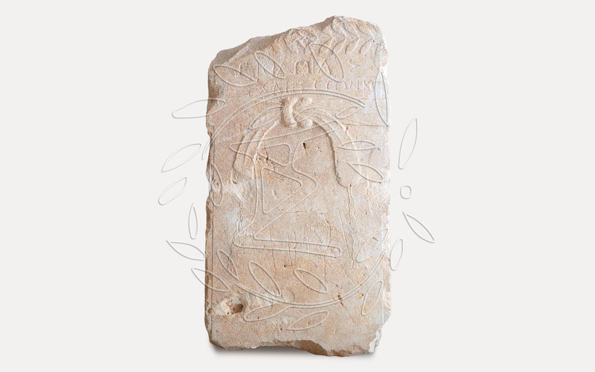 Grave stele of midwife or “iatrini” Isidora with incised medical instruments.
